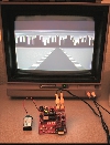 The XGS Pico Edition PCB running the "Racer City" demo on a TV.